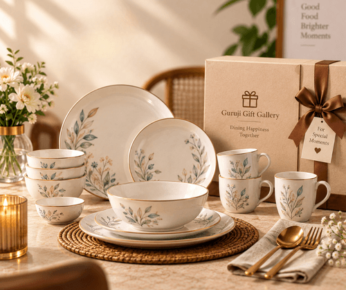 Floral ceramic dinner set with plates, bowls, mugs and gold cutlery beside a gift box